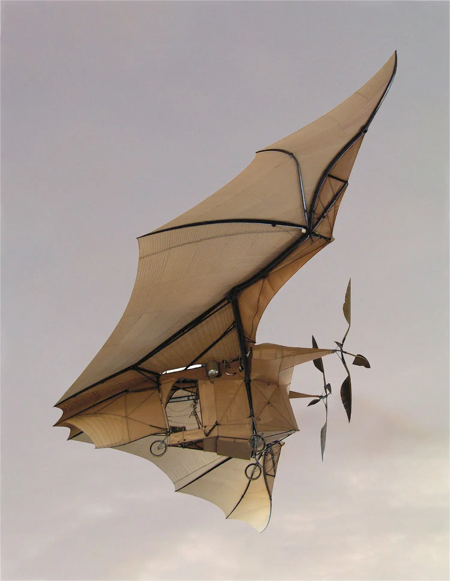An old, experimental aircraft that appears to be made of canvas and metal tubing. An old, experimental aircraft that appears to be made of canvas and metal tubing.